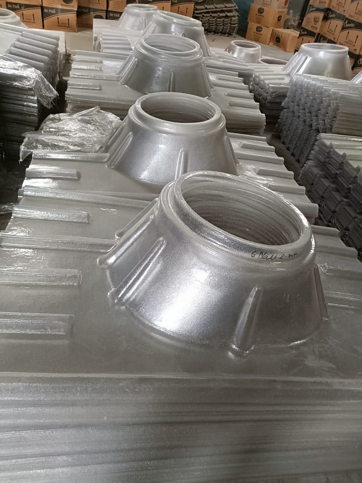 Polycarbonate ventilator bases in bulk stock, ready for dispatch and installation.