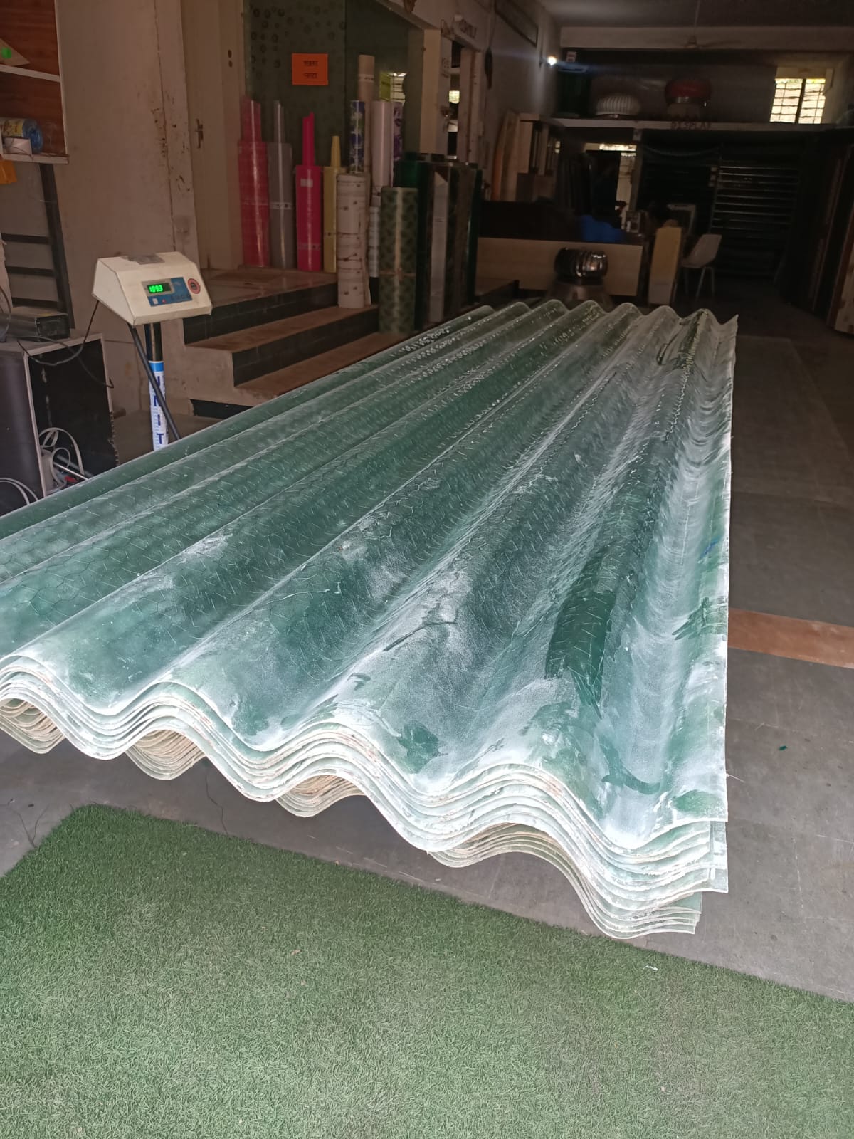 Translucent FRP sheet in ACC nali design kept on stand during production.