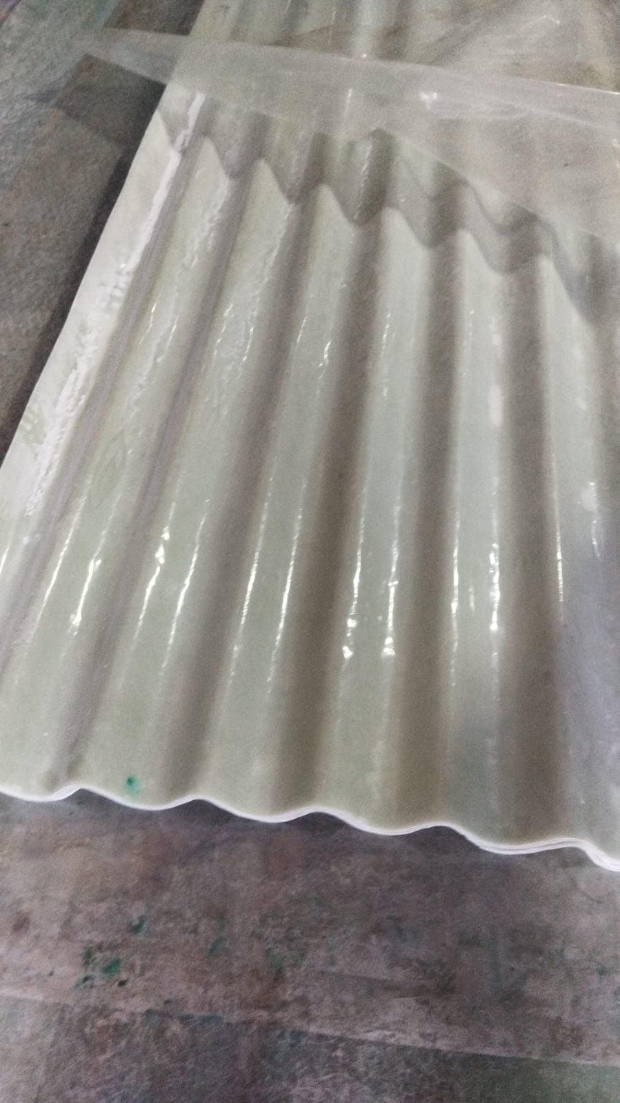 FRP ACC nali design sheet stacked, showing profile edges and surface texture.