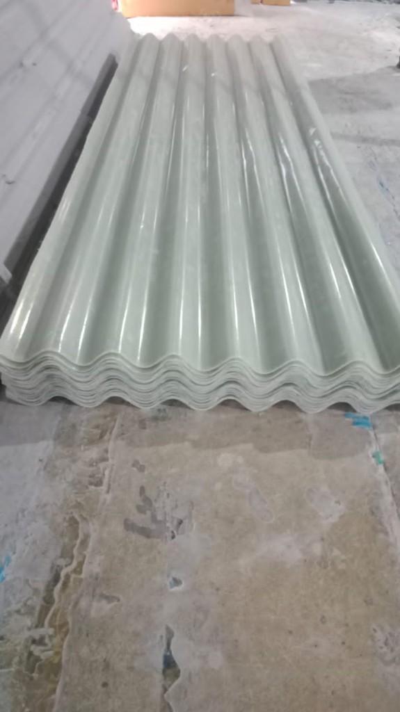 Stack of FRP ACC nali sheets in matching roof profile, ready for installation as long-life rainwater gutters.