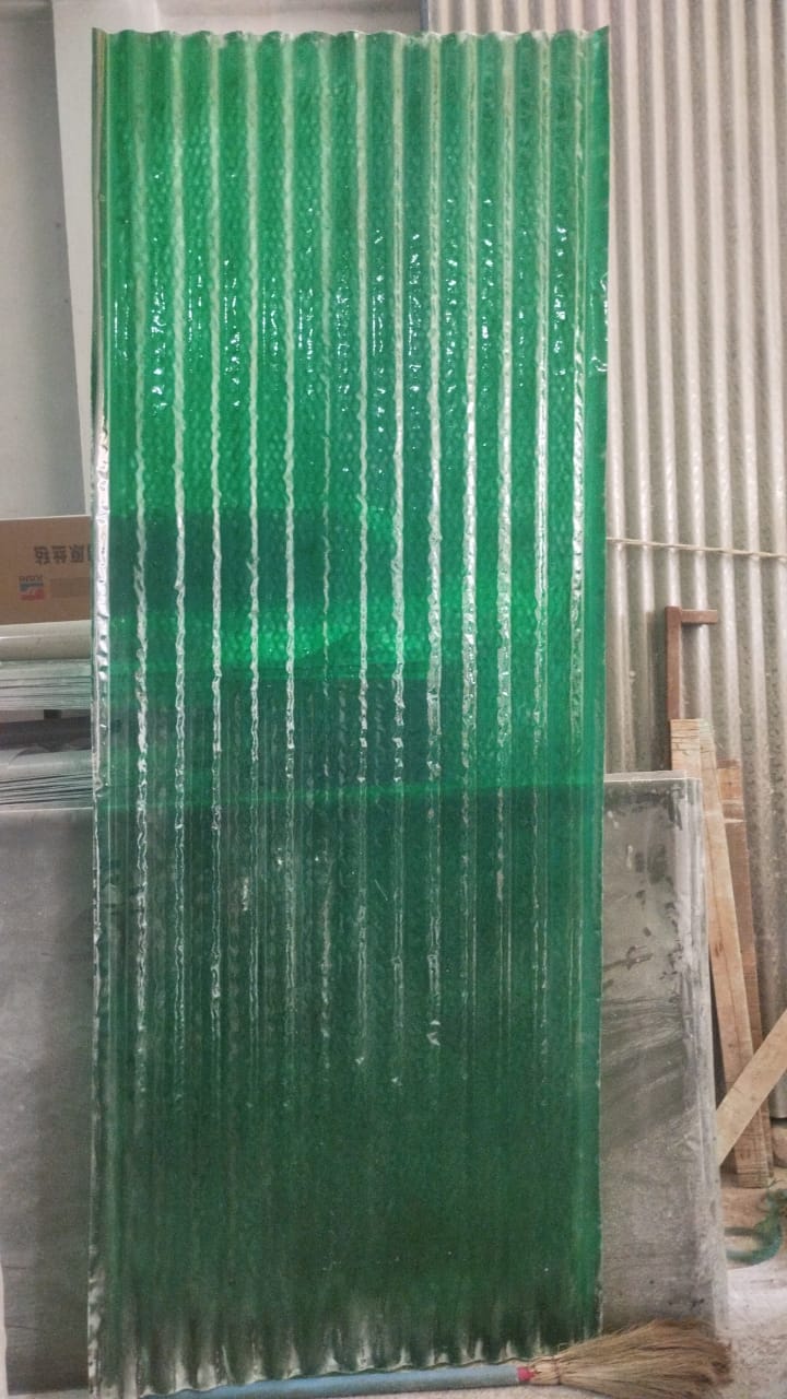 Green translucent FRP corrugated sheet panel standing upright, showing ribbed profile and light transmission.