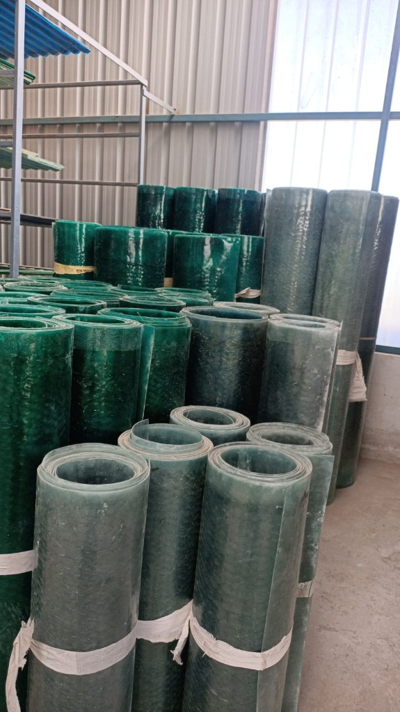 Multiple FRP plain sheet rolls in green translucent finish, ready for dispatch from stock.