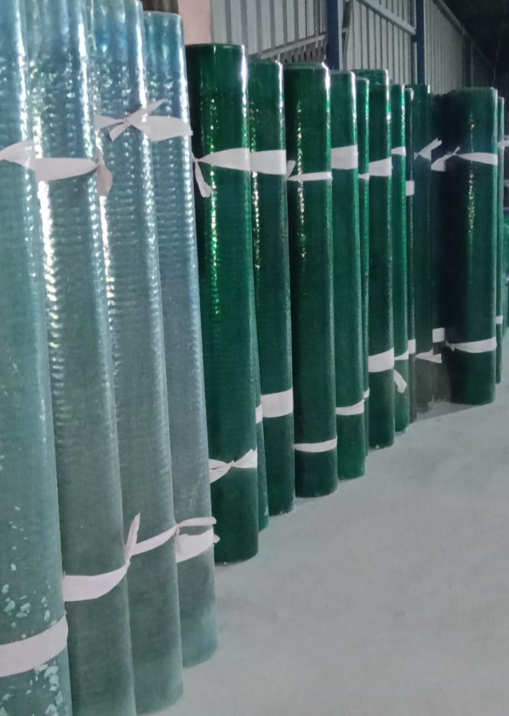 Row of FRP plain sheet rolls in different green tones, ideal for long-length roofing, skylights, and wall lining.