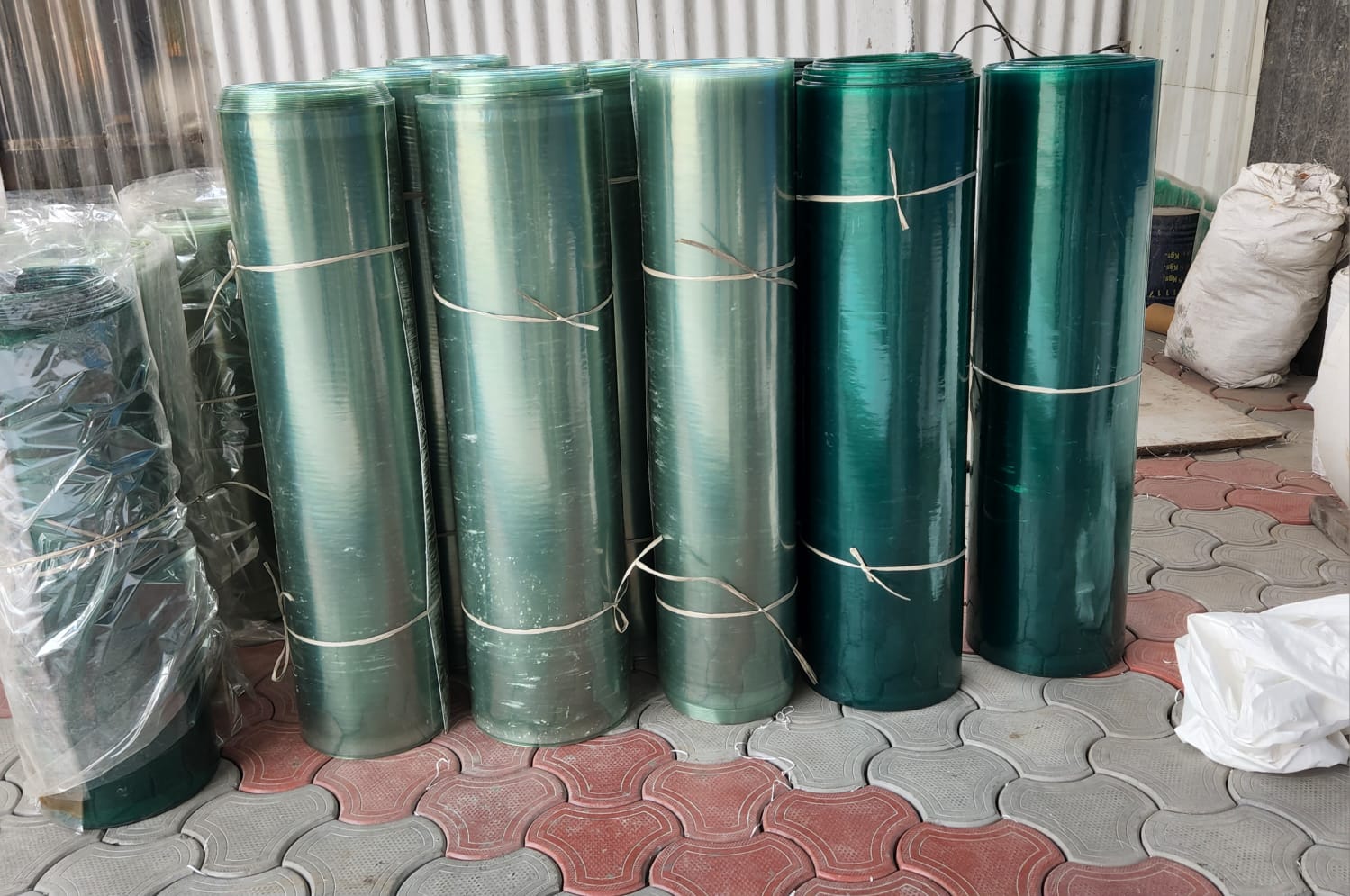 FRP plain sheet rolls in green translucent shades, packed and ready for dispatch.