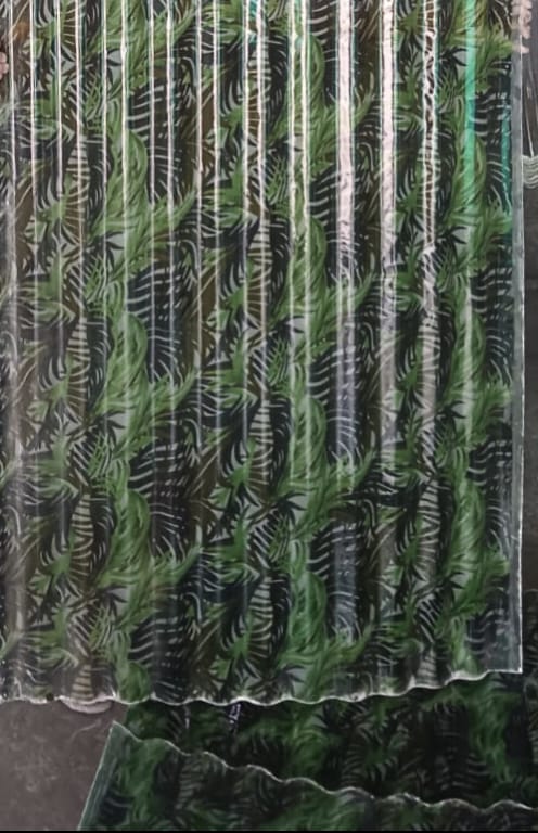 FRP printed sheet panel held for inspection, showing print clarity and translucency.