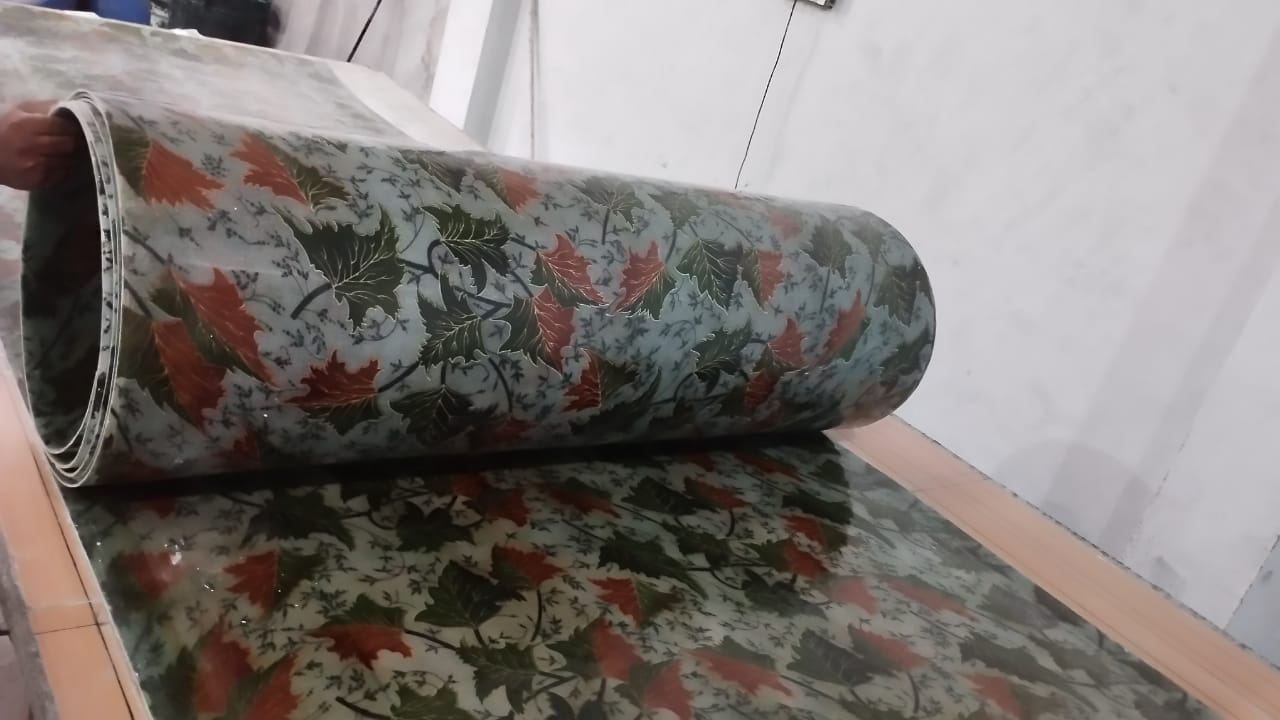 Printed FRP sheet roll on table, showing continuous printed film finish.