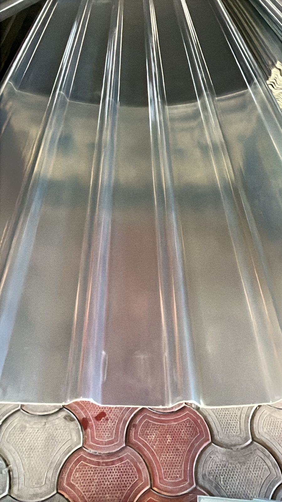 Clear translucent FRP profile sheet close-up showing corrugation and light transmission.
