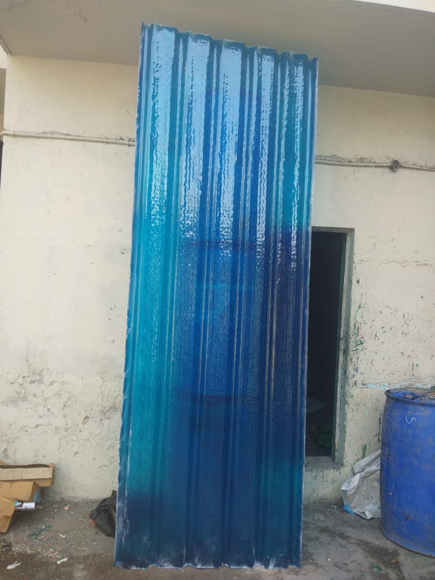 Large blue corrugated FRP profile sheet with gradient finish, in industrial setting.