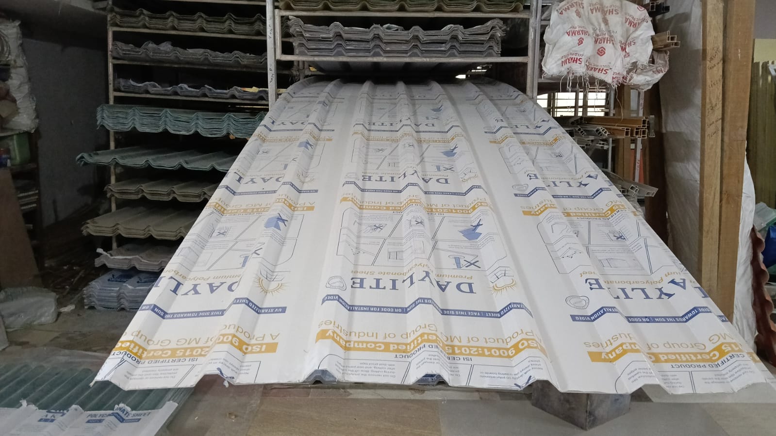 White corrugated polycarbonate profile sheet showing ribbed profile and glossy finish.